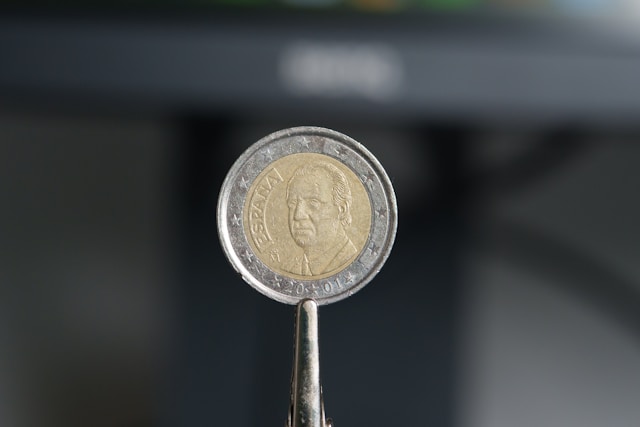 a-close-up-of-a-key-with-a-coin-on-it
